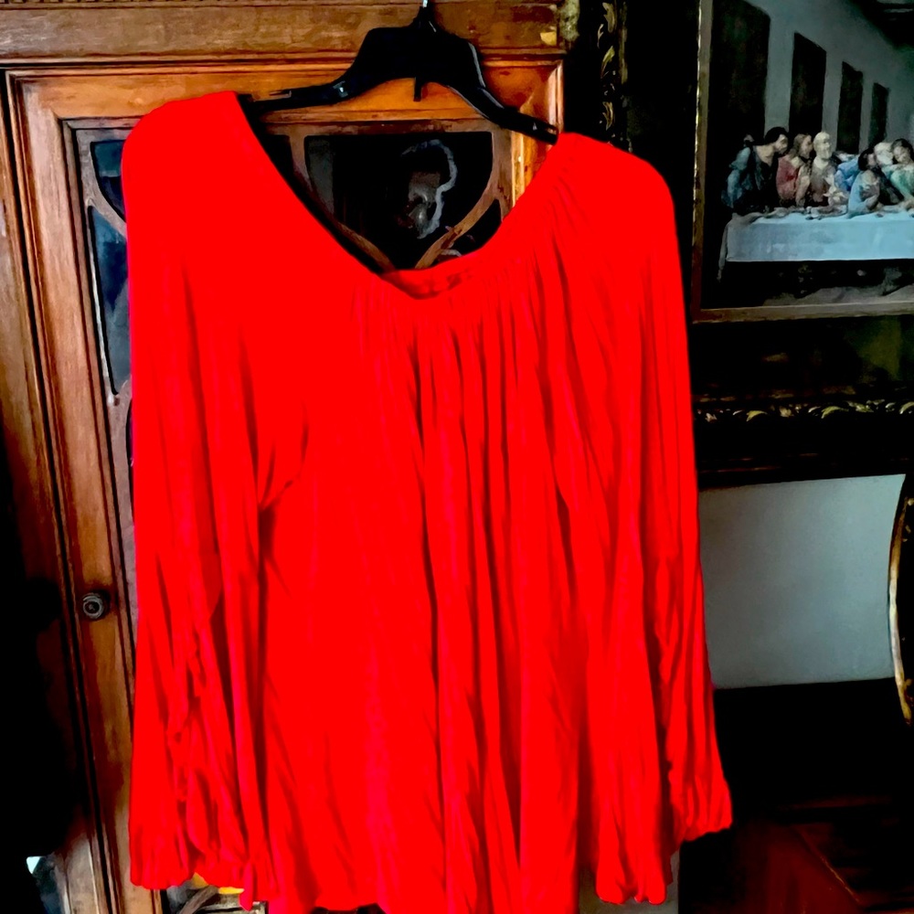 Bright red shirt with ruffled sleeves. Long enough to be worn with leggings